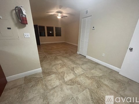 A room with a tiled floor and a ceiling fan.