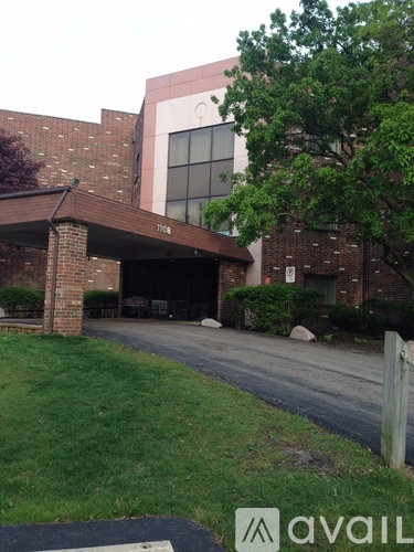 A brick building with a tree in front of it.