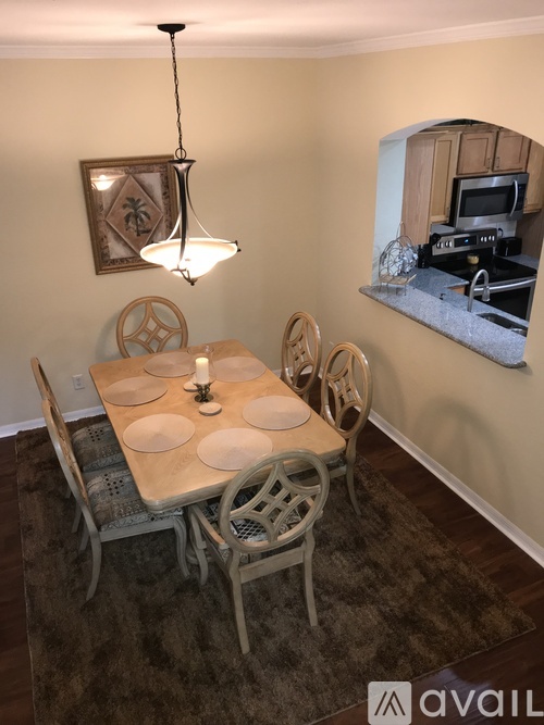 A dining room with a table set for four.