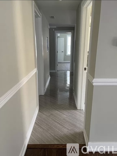 A hallway with a white door at the end.