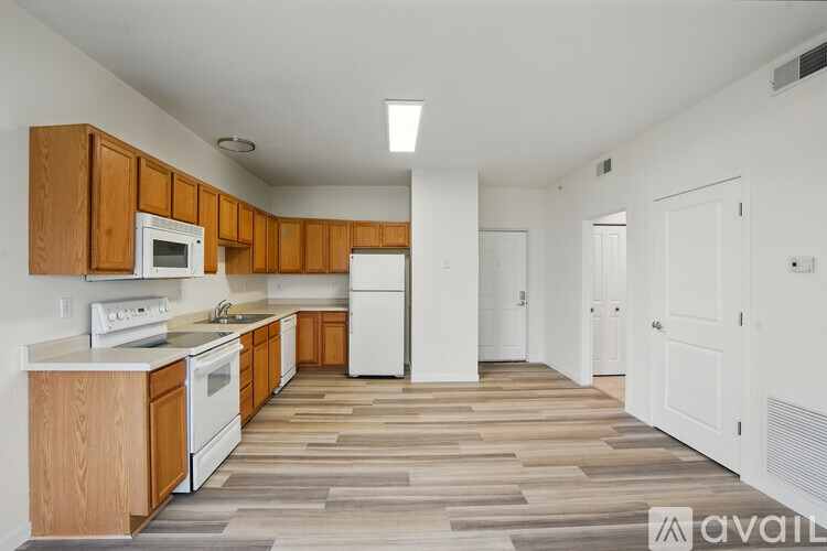A kitchen with wooden cabinets and a white refrigerator.