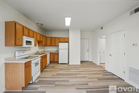 A kitchen with wooden cabinets and a white refrigerator.