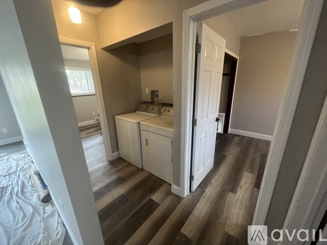 A bedroom with a bed, dresser, and mirror.