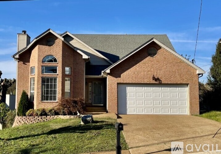 A house with a garage is for sale.