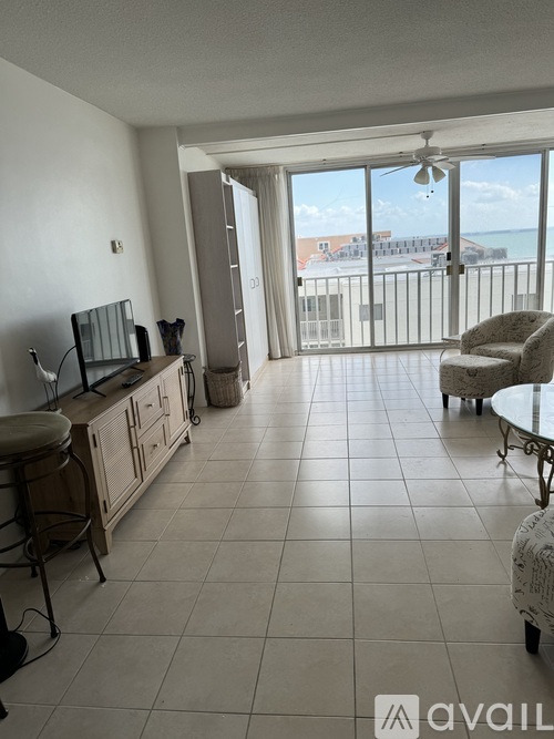 A living room with a view of the beach.