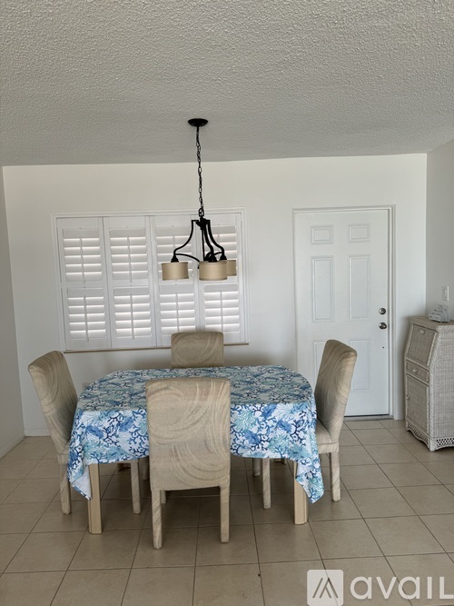 A dining room with a table set for four.