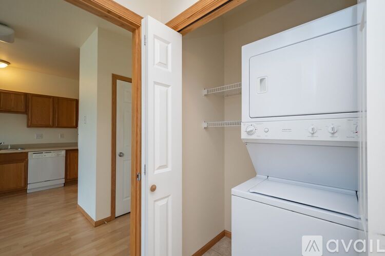 A white fridge and oven in a kitchen with a door open.