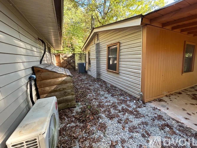 A backyard with a shed and a washing machine.