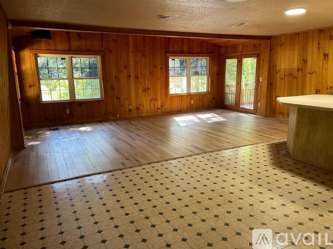 A room with wooden walls and a checkered floor.