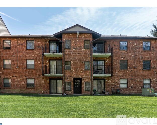 A red brick building with a balcony on the second floor.