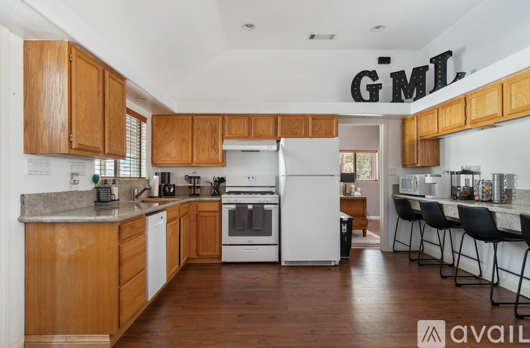 A kitchen with wooden cabinets and a white refrigerator.