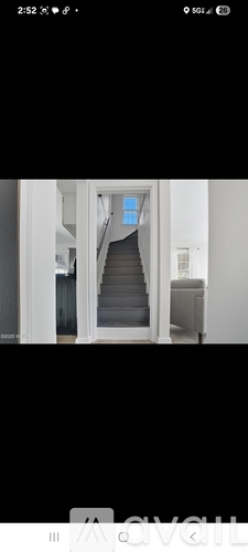 A staircase with a blue door at the top.