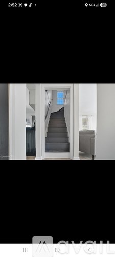 A staircase with a blue door at the top.