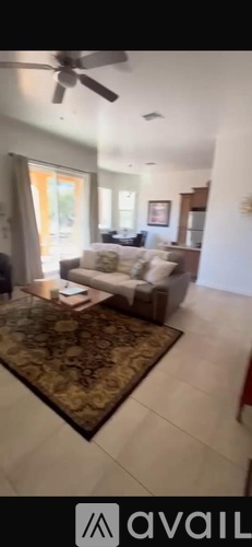 A living room with a rug and a couch.