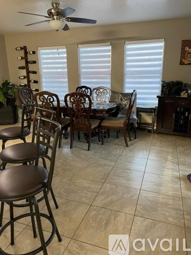 A dining room with a table and chairs.