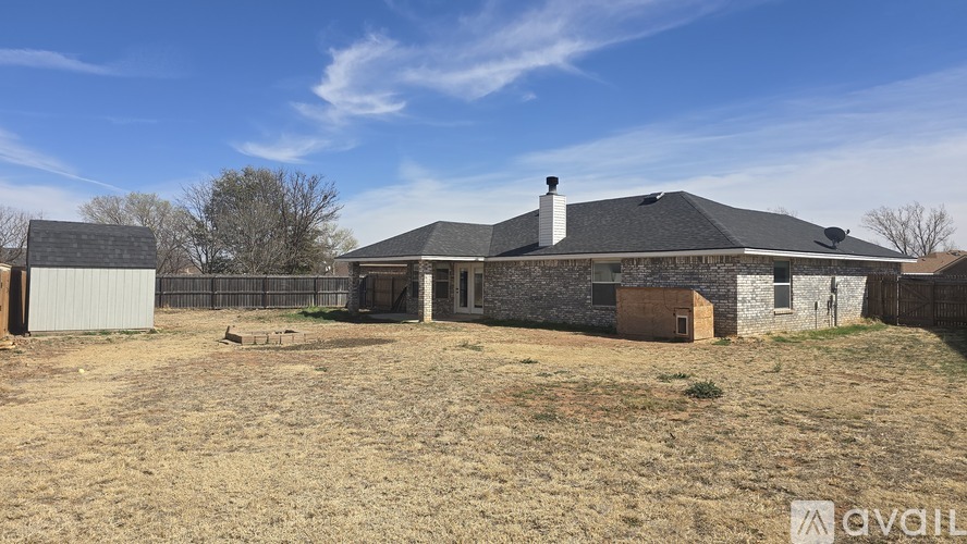 A house with a stone wall and a metal shed is available for purchase.