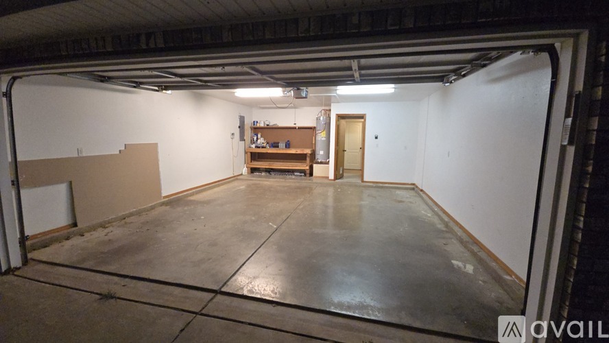 A large, empty garage with a concrete floor and white walls.