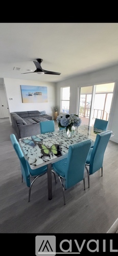 A dining room with a table set for four.