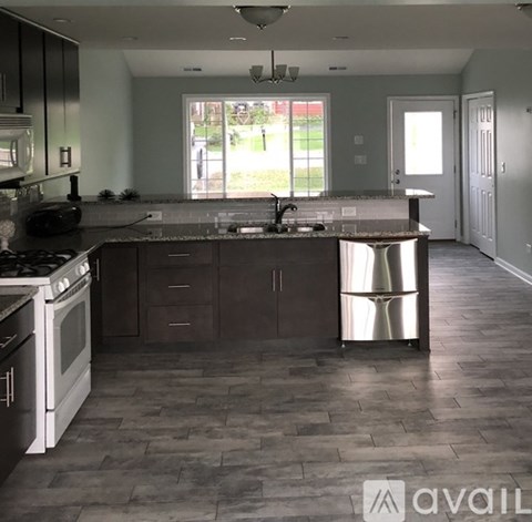 A kitchen with a large island and a stove top oven.