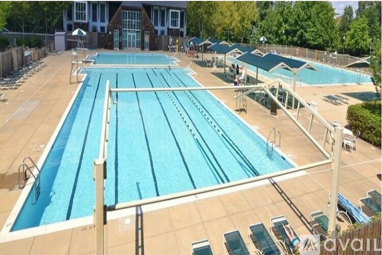 A large outdoor swimming pool with multiple lanes and a diving board.