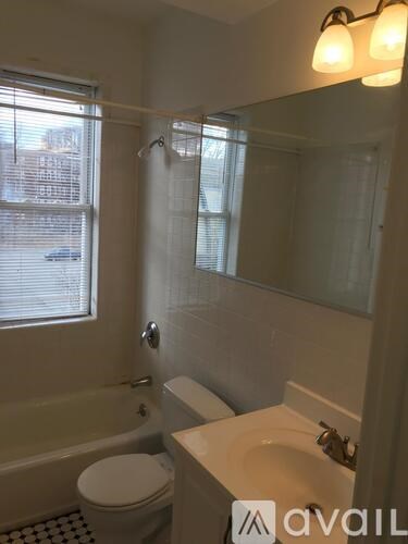 A bathroom with a toilet, sink, and bathtub.