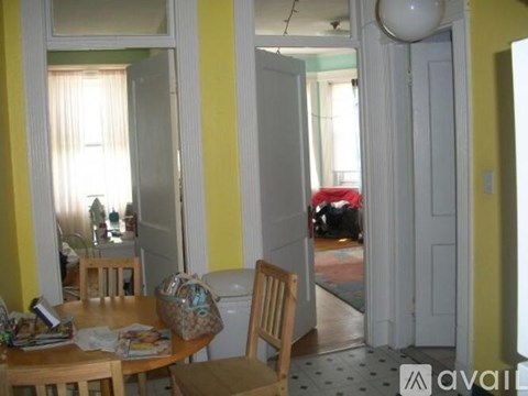 A dining room with a table and chairs.