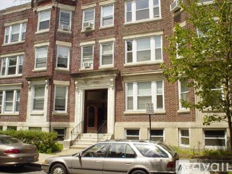 A building with a car parked in front of it.
