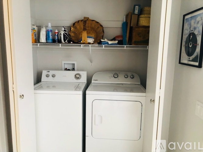 A small laundry room with a washer and dryer.
