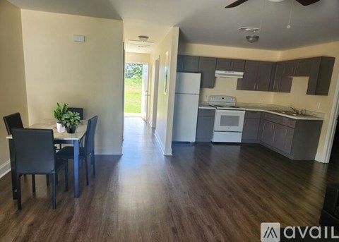 A kitchen with a dining table and chairs is available for rent.