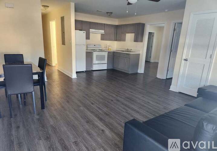 A modern kitchen with a dining table and chairs in a spacious room.