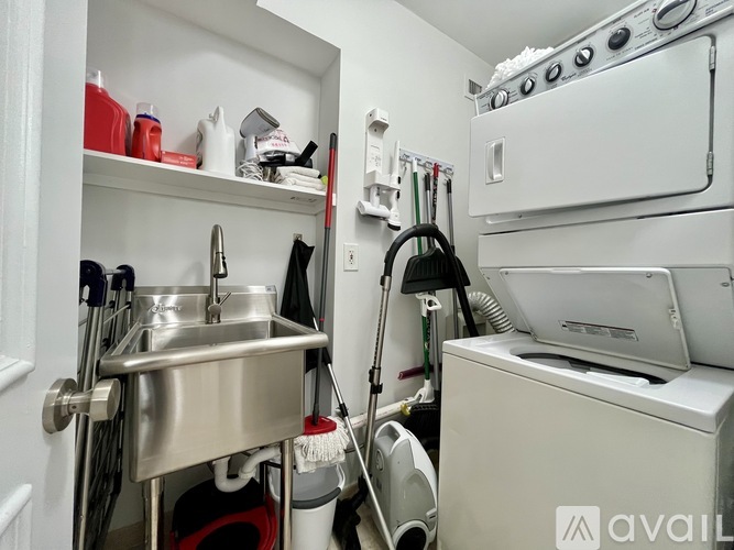 A small kitchen with a sink, a dishwasher, and a stove top oven.