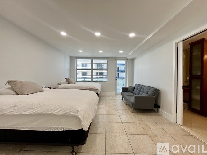 A bedroom with a large bed and a couch.