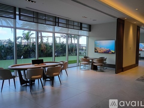 A modern dining room with a large table and chairs.