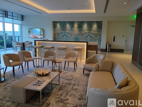 A living room with a large painting on the wall and a variety of seating options.