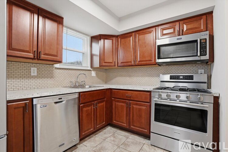 A kitchen with wooden cabinets and stainless steel appliances.