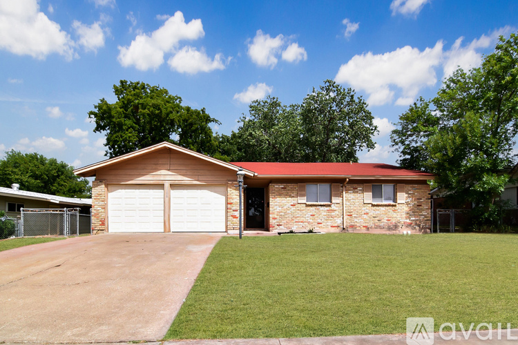 A house with a red roof and a garage door.