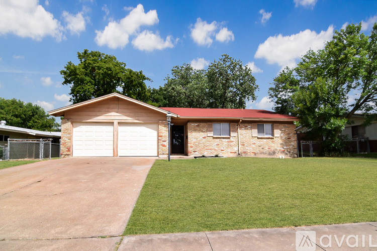 A house with a red roof and a garage door.