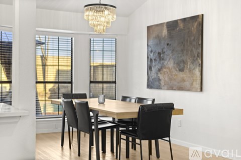 A dining room with a wooden table and chairs.