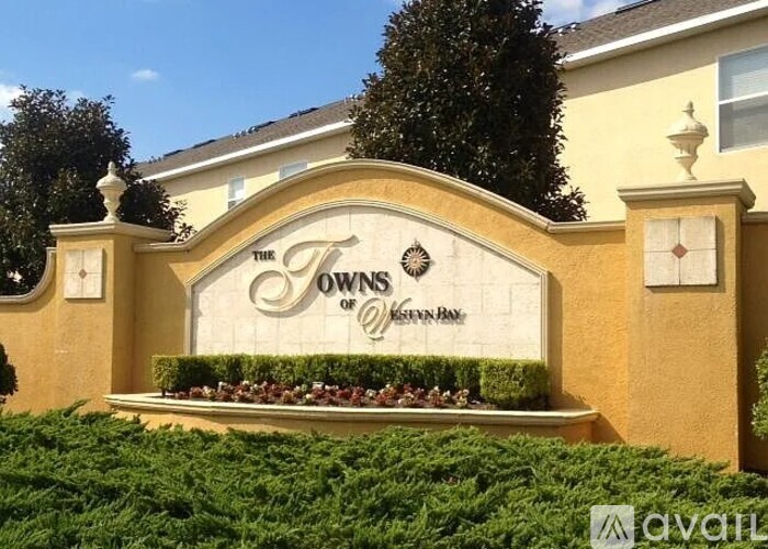 A sign that says "Towns of Keenan Park" is displayed in front of a building.