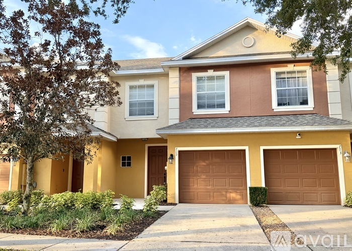 A two-story house with a garage on the right side.