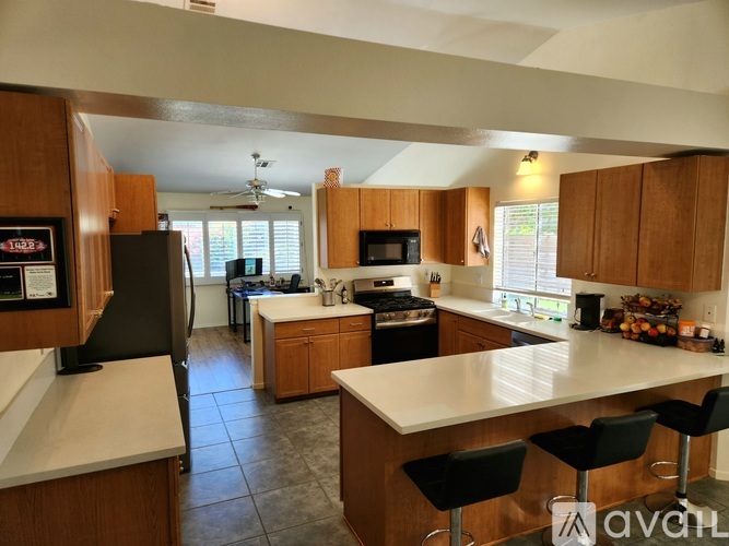 A kitchen with wooden cabinets and a white countertop.