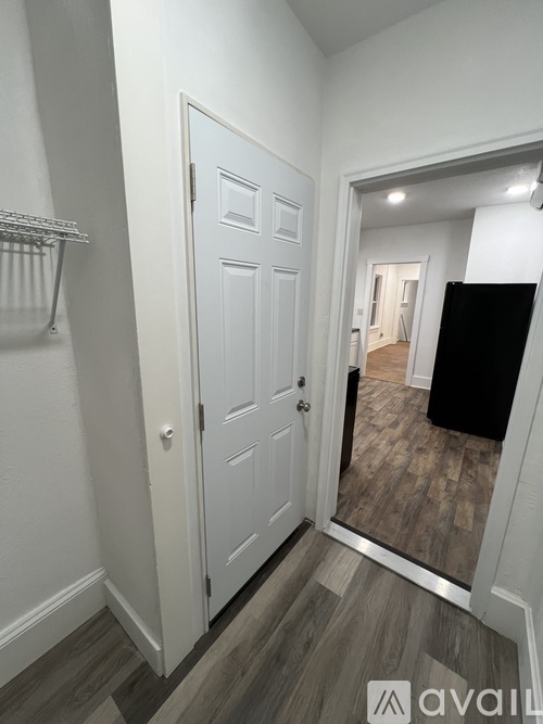 A white door with a mirror on the right side.