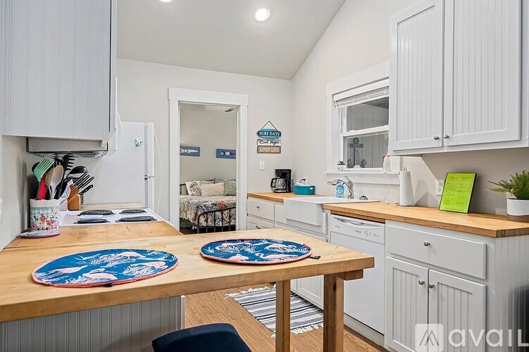 A kitchen with a table and chairs in the middle of it.