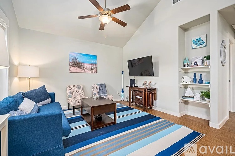 A living room with a blue couch and a television.