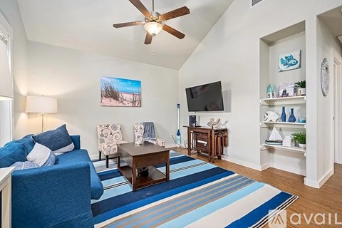 A living room with a blue couch and a television.