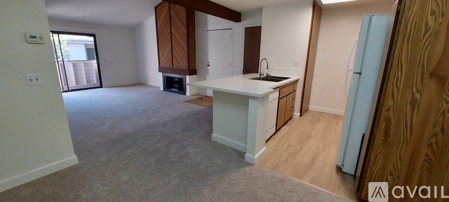 A kitchen with a white countertop and a blue refrigerator.
