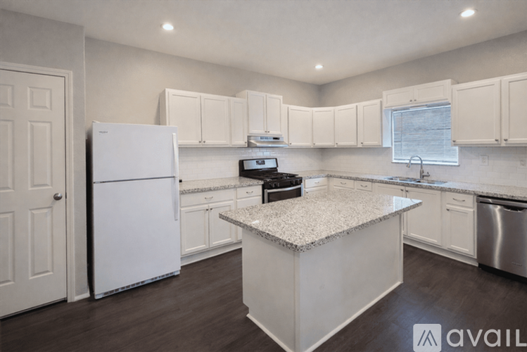A kitchen with white appliances and cabinets.