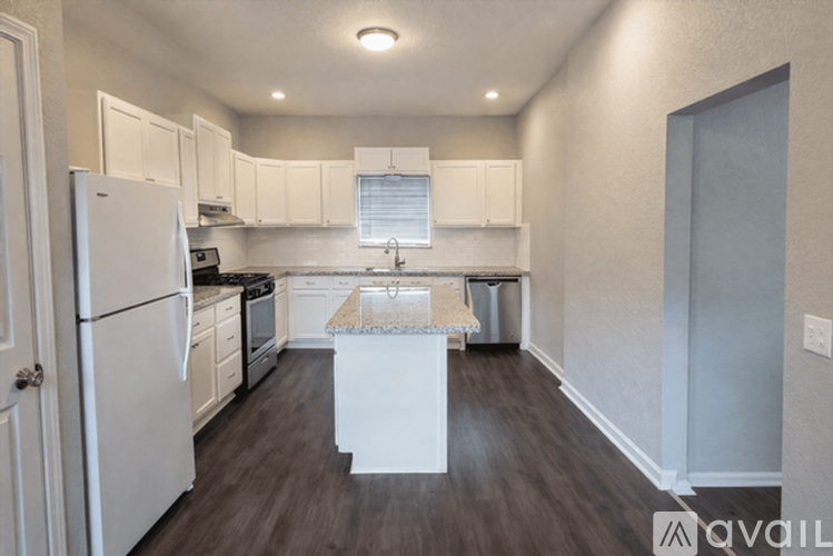 A kitchen with white appliances and cabinets.