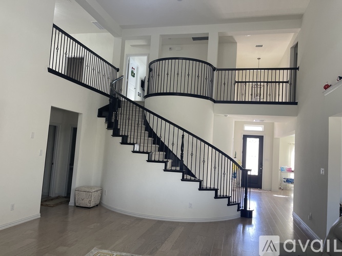 A large, empty house with a spiral staircase.