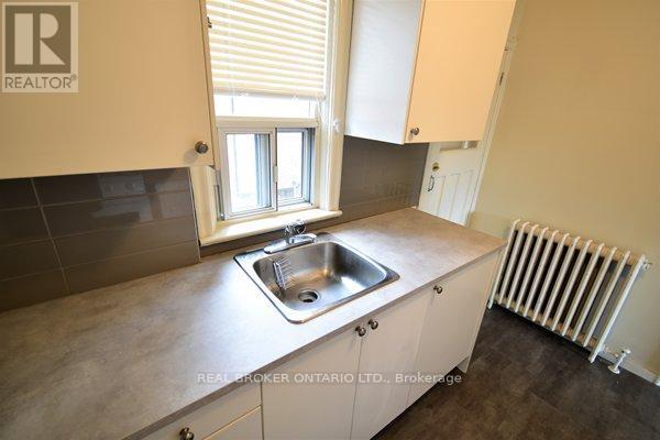 A kitchen with a sink and a window.